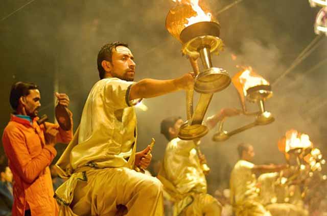 Priests performing the evening Ganga Aarti with lamps at Dashashwamedh Ghat, Varanasi